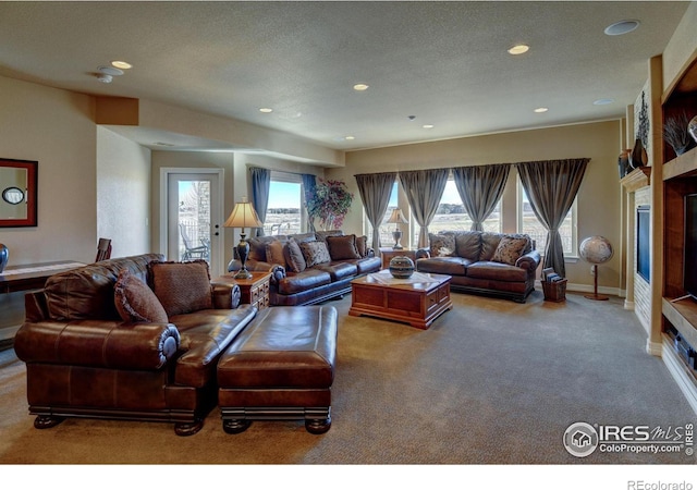 living area featuring a textured ceiling, carpet, and recessed lighting