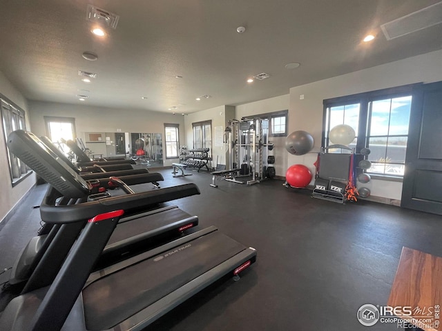 exercise room with visible vents and recessed lighting