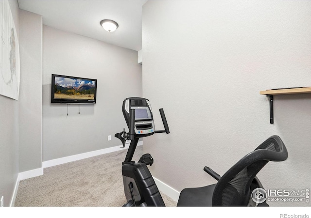 exercise room with carpet floors and baseboards