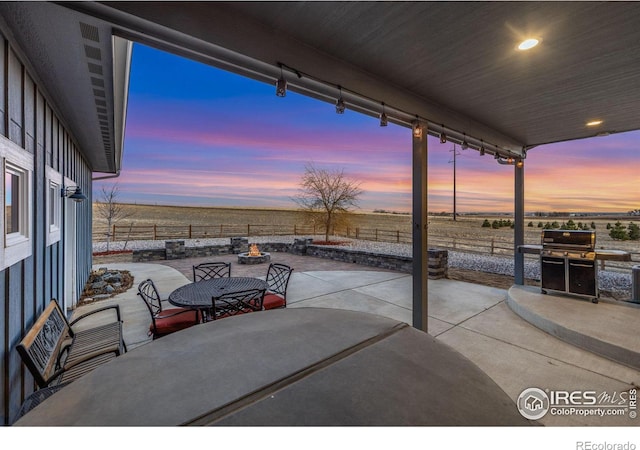 view of patio / terrace with outdoor dining area, a fenced backyard, and a grill