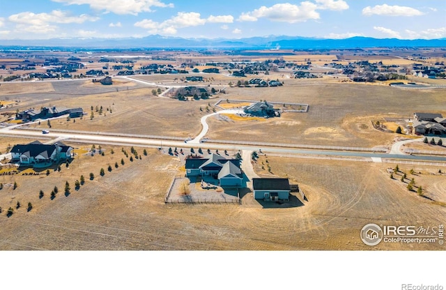 drone / aerial view featuring a rural view and a mountain view