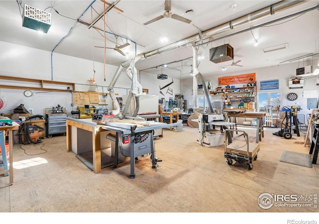 misc room with concrete floors, a workshop area, and a ceiling fan