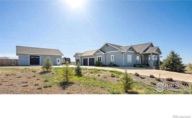 view of front of house with board and batten siding, an attached garage, and driveway