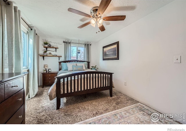 bedroom featuring a ceiling fan and light colored carpet