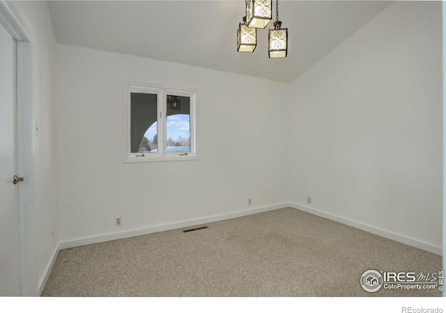 carpeted empty room featuring baseboards and visible vents