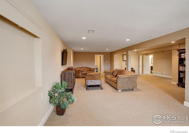 living area with carpet, visible vents, baseboards, and recessed lighting