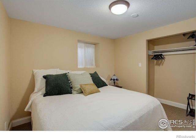 carpeted bedroom featuring a closet and baseboards