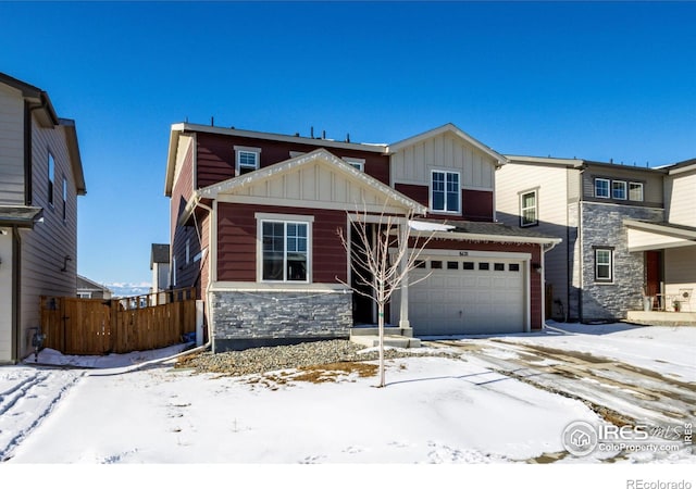 view of front of house with an attached garage, stone siding, and board and batten siding