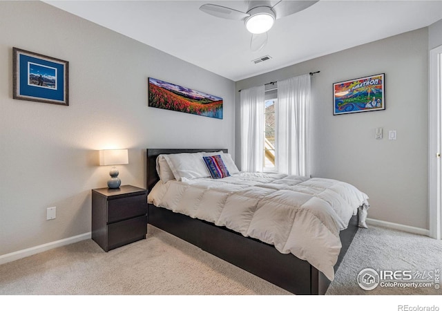 carpeted bedroom with visible vents, ceiling fan, and baseboards