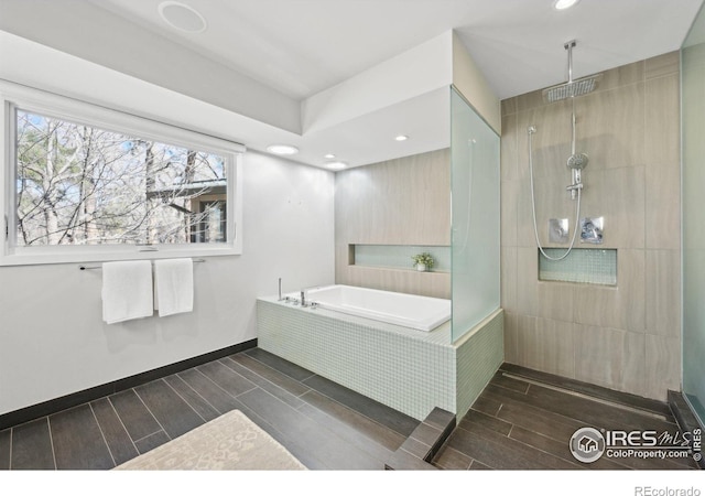 full bathroom with baseboards, wood tiled floor, a walk in shower, a bath, and recessed lighting