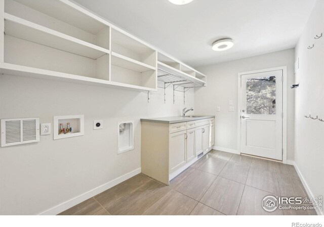 clothes washing area with hookup for an electric dryer, laundry area, washer hookup, a sink, and visible vents