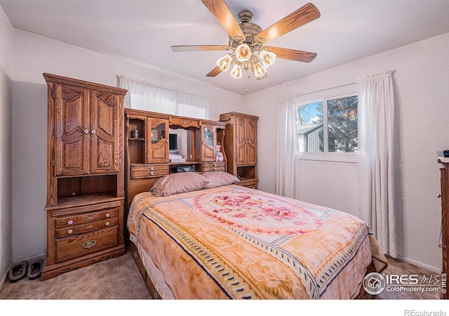 bedroom featuring light colored carpet and ceiling fan