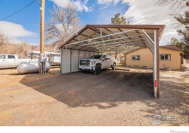 view of car parking featuring driveway and a detached carport