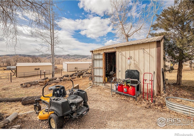 view of shed with fence and a mountain view