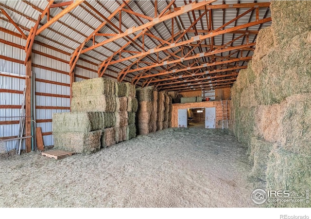 miscellaneous room with lofted ceiling and metal wall