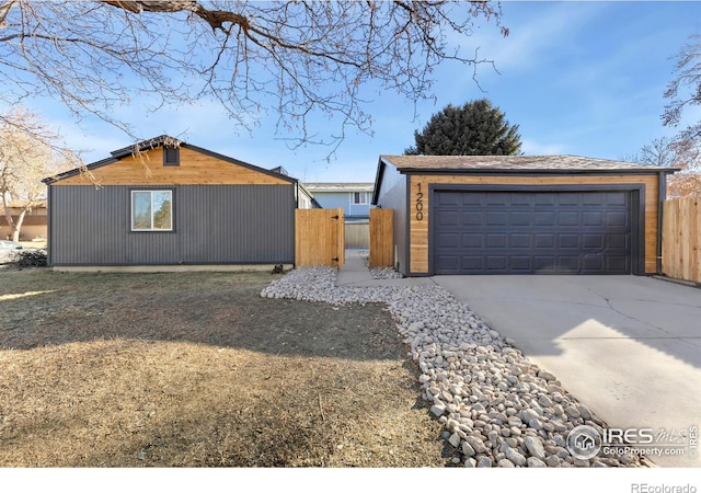 view of front of property with an outbuilding and fence