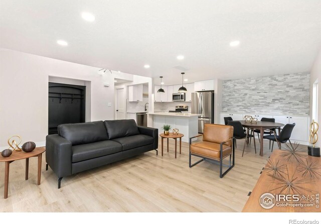 living area featuring recessed lighting and light wood finished floors