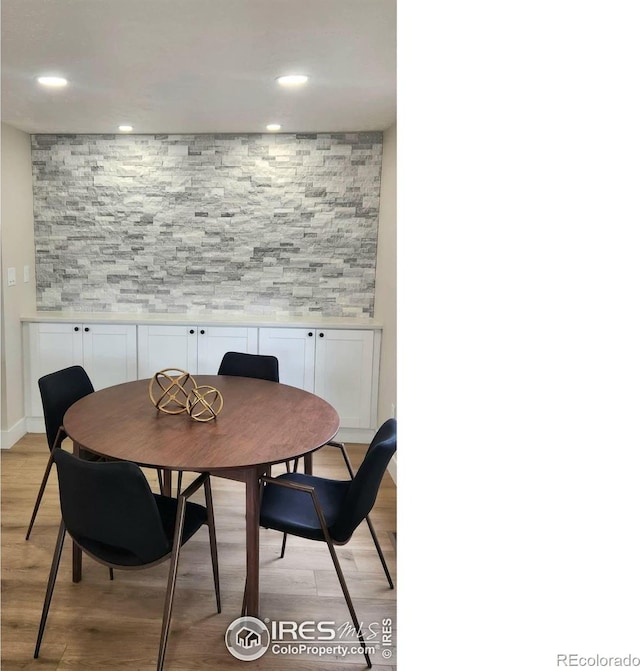 dining room with light wood-style floors and recessed lighting