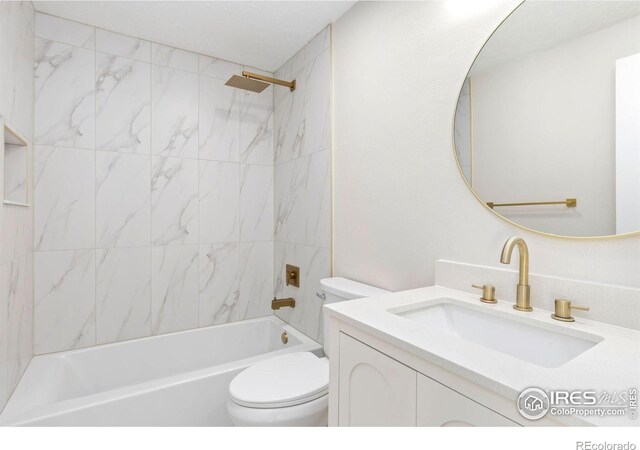 full bathroom featuring washtub / shower combination, vanity, and toilet