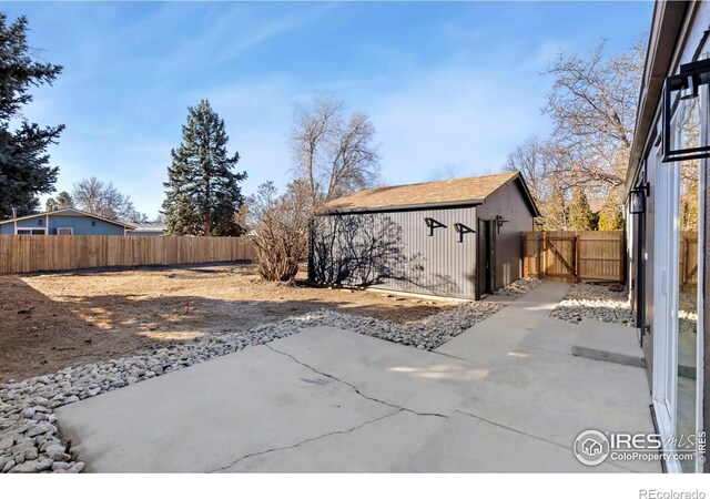 view of patio / terrace featuring an outdoor structure and a fenced backyard