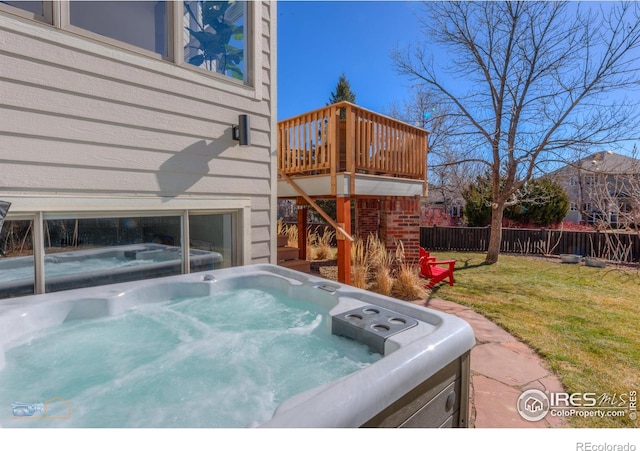 exterior space with a hot tub and fence