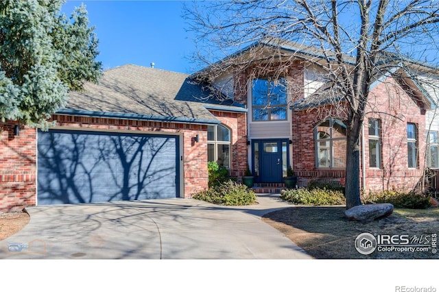 view of front of property with a garage, driveway, a shingled roof, and brick siding