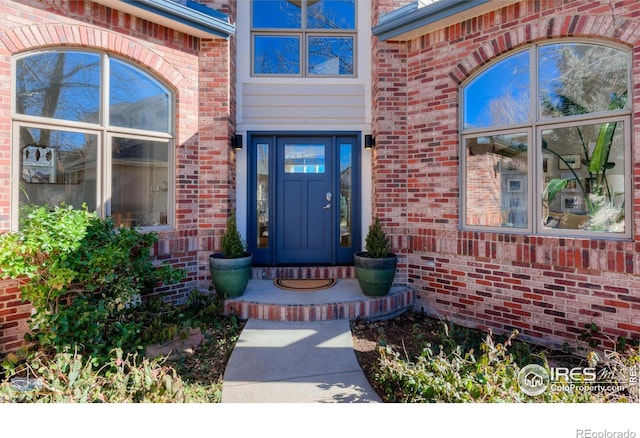 entrance to property with brick siding