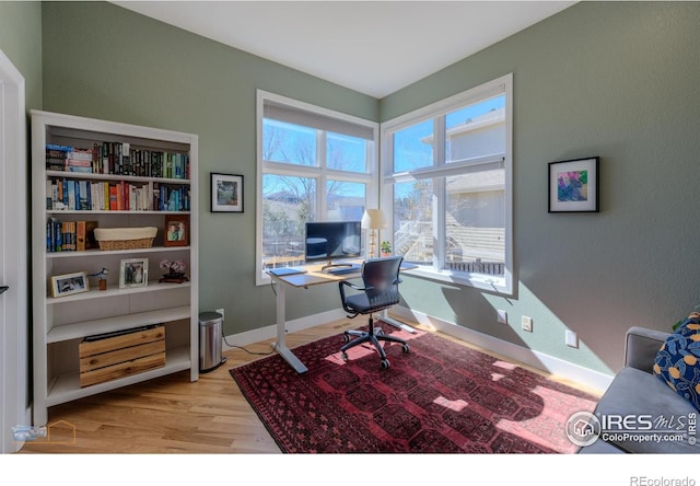 office featuring light wood-style floors and baseboards