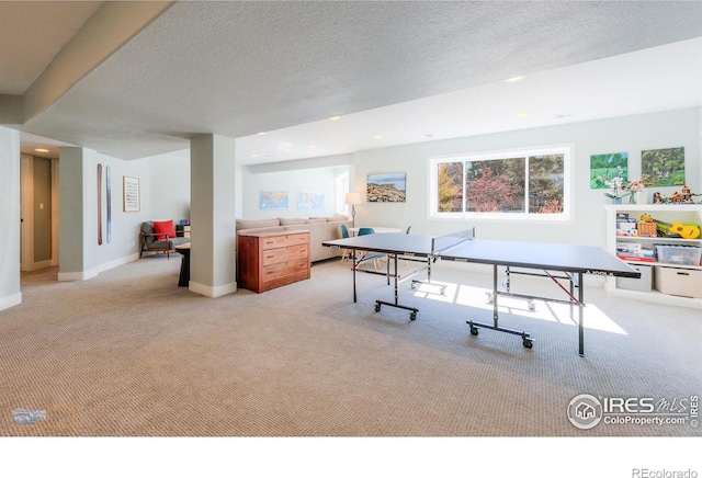 recreation room featuring light carpet, a textured ceiling, baseboards, and recessed lighting