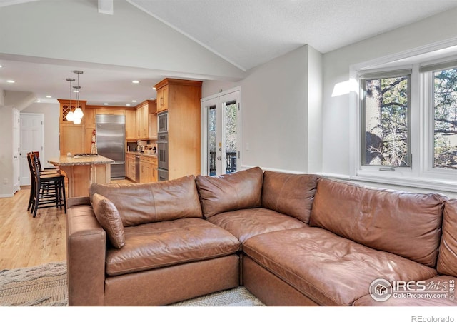 living room featuring french doors, light wood finished floors, lofted ceiling, recessed lighting, and a textured ceiling