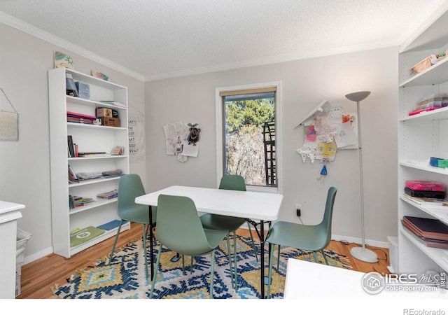 office with ornamental molding, a textured ceiling, baseboards, and wood finished floors