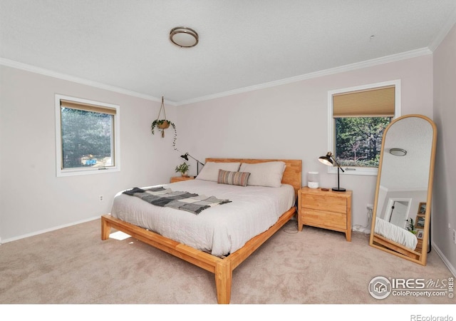 bedroom with baseboards, carpet floors, and crown molding