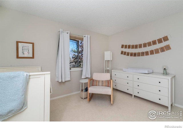 bedroom with light carpet, baseboards, vaulted ceiling, and a textured ceiling