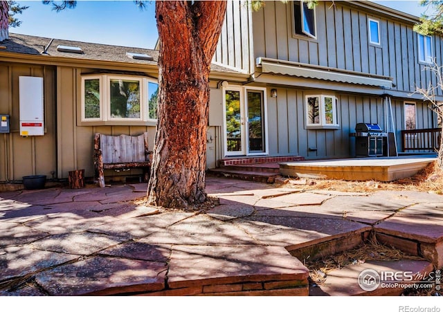 rear view of property featuring a patio and board and batten siding