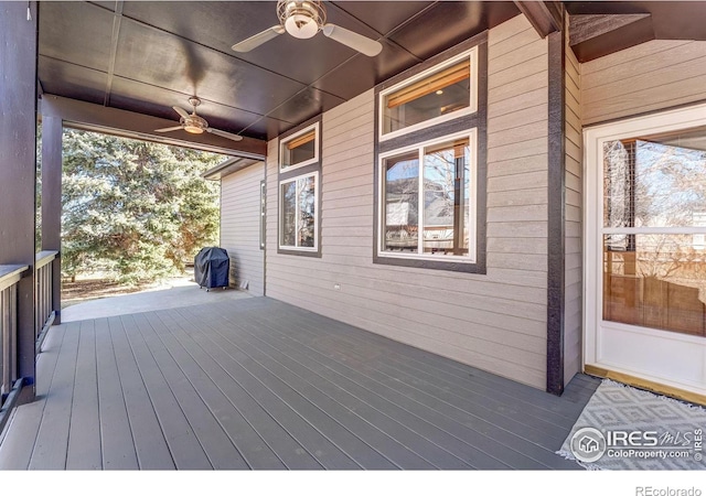 wooden terrace featuring a ceiling fan