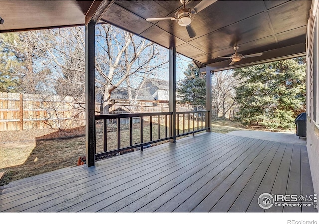 wooden terrace with a fenced backyard and ceiling fan