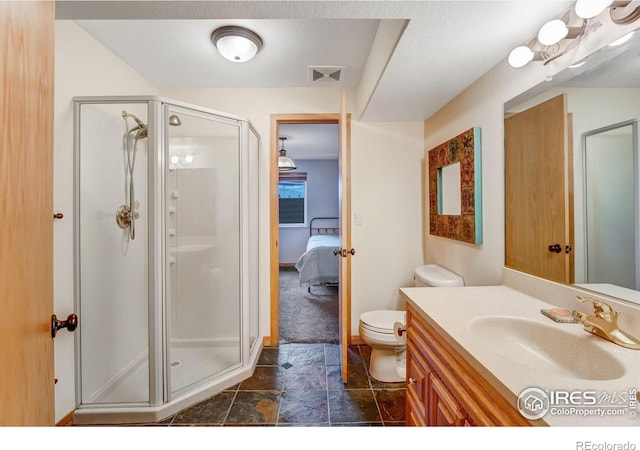 bathroom featuring visible vents, toilet, ensuite bathroom, a stall shower, and vanity