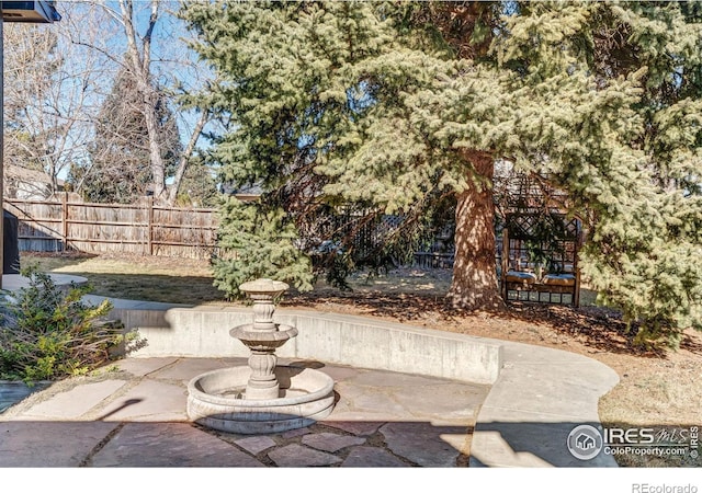 view of patio featuring fence