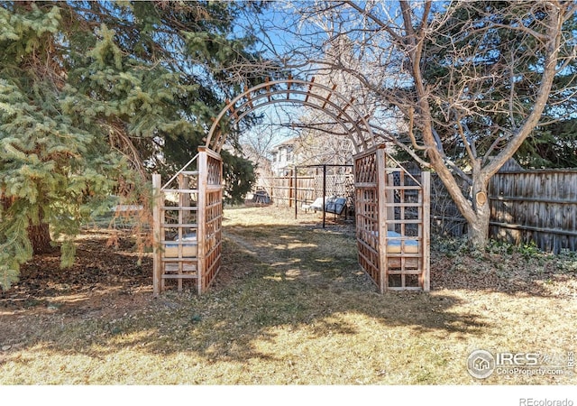 view of yard with fence and a playground