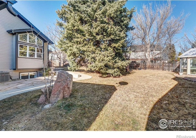 view of yard featuring fence and cooling unit