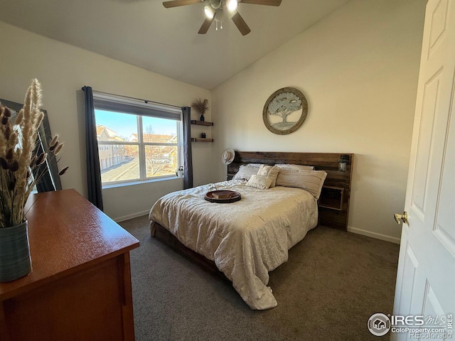 bedroom featuring vaulted ceiling, baseboards, dark colored carpet, and a ceiling fan