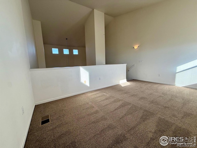 spare room with carpet floors, baseboards, and visible vents