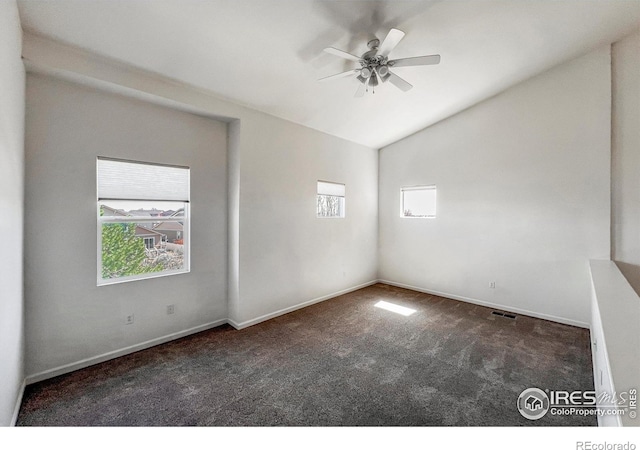 1004 Lucca Dr, Evans, CO 80620 - carpeted empty room featuring visible vents, a ceiling fan, lofted ceiling, and a healthy amount of sunlight