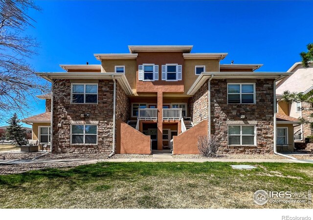 1004 Lucca Dr, Evans, CO 80620 - rear view of house with stucco siding and stone siding