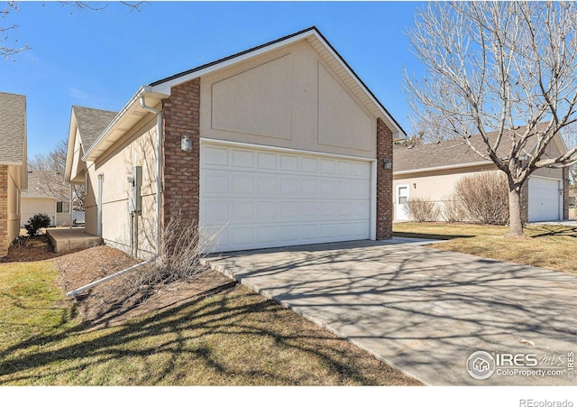 garage featuring concrete driveway