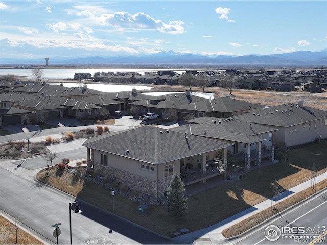 bird's eye view with a residential view and a water and mountain view