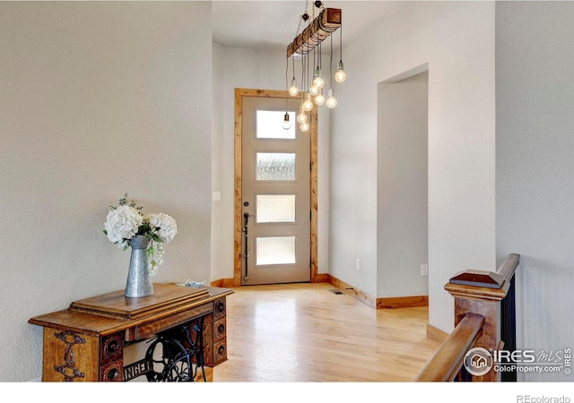 entrance foyer with baseboards and light wood-style flooring