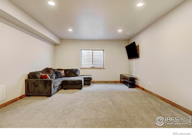 carpeted living area with recessed lighting, baseboards, and visible vents