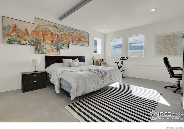 bedroom featuring concrete flooring and recessed lighting