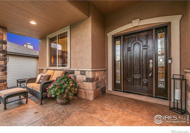 7007 Spanish Bay Dr, Windsor, CO 80550 - property entrance featuring stucco siding and covered porch